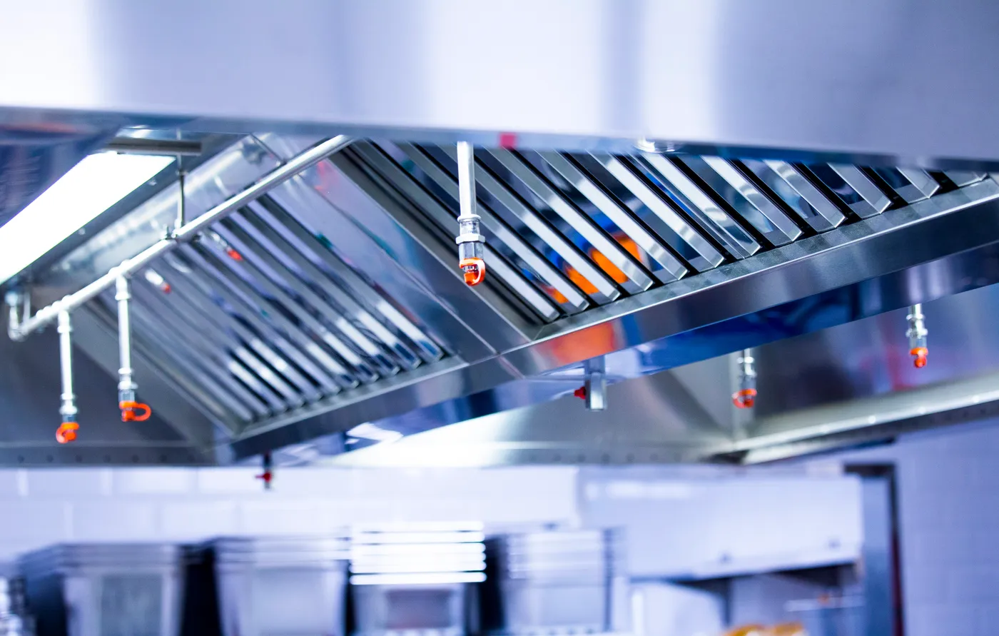 Stainless commercial kitchen exhaust hood with wet chemical suppression nozzles