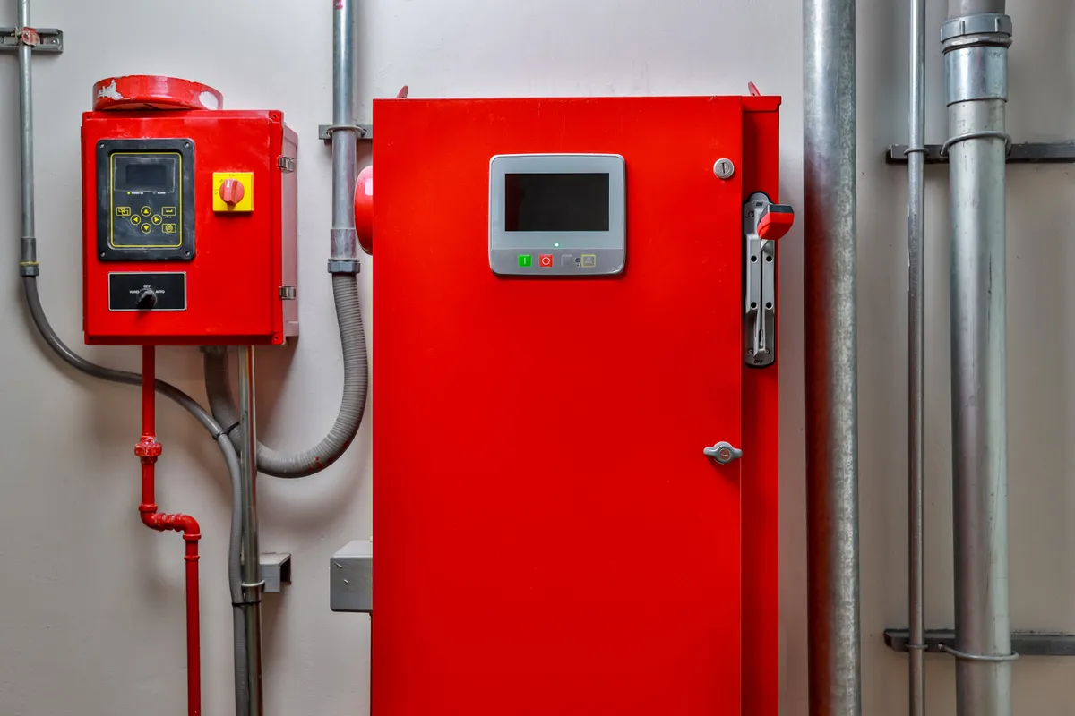 Red fire pump controller cabinet in a fire pump room
