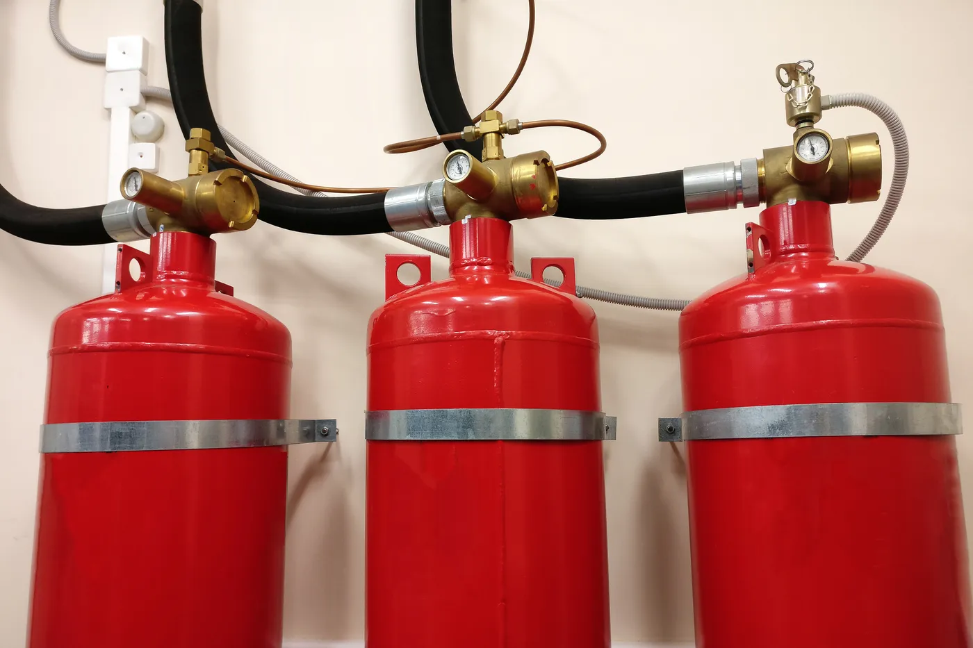 High-pressure gaseous fire suppression cylinders with brass control valves